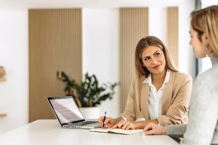 A surrogate mother in a thoughtful conversation with her boss at work